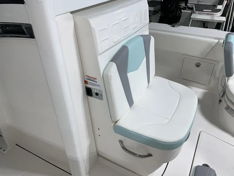 Slide: The Image of 2024 Robalo 266 Cayman boat seat with white and teal upholstery. - 10