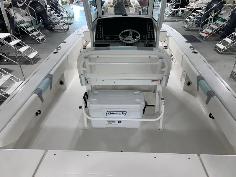 Slide: The Image of 2024 Robalo 266 Cayman boat interior with Coleman cooler and steering console. - 4
