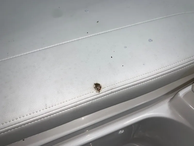 Slide: The Image of Damaged upholstery on 2024 Robalo 266 Cayman boat seat. - 5