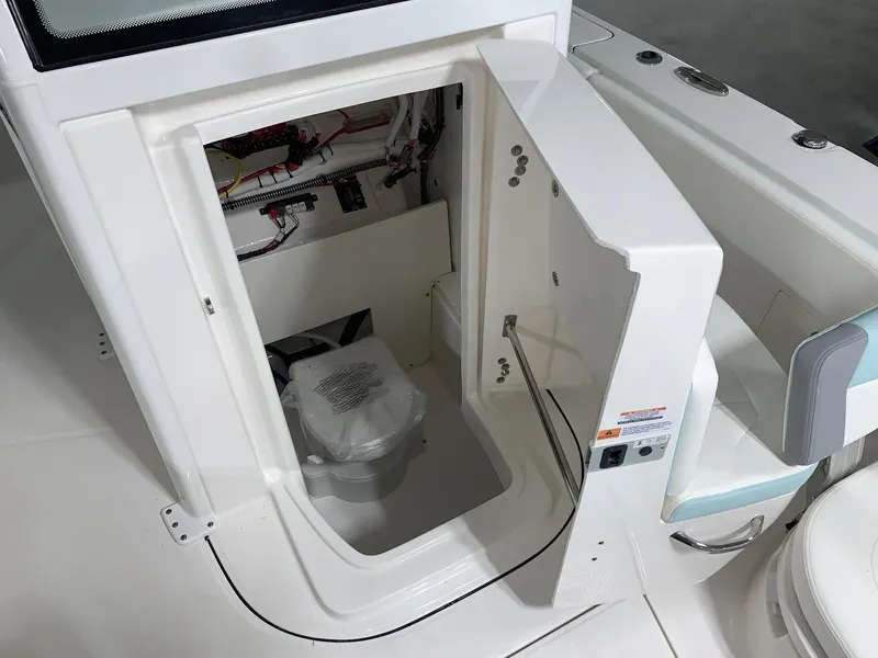 Slide: The Image of 2024 Robalo 266 Cayman boat interior storage compartment with access door open. - 11