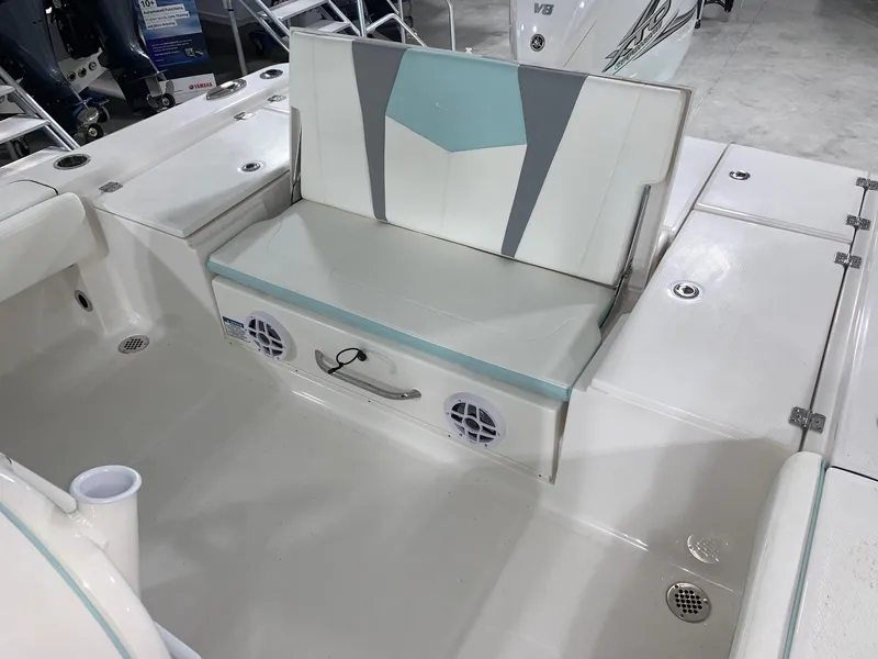 Slide: The Image of 2024 Robalo 266 Cayman boat interior with foldable seat and storage compartment. - 17