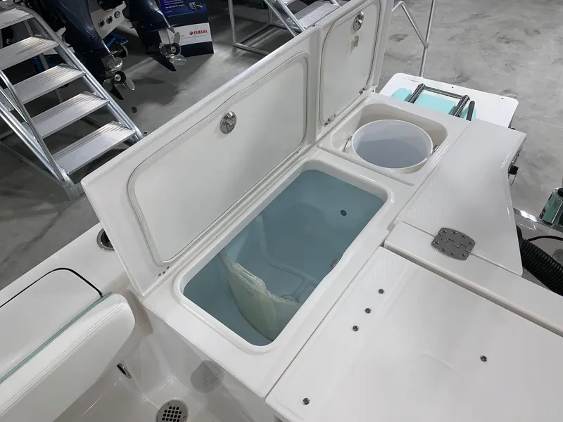 Slide: The Image of 2024 Robalo 266 Cayman boat livewell and storage compartments. - 18