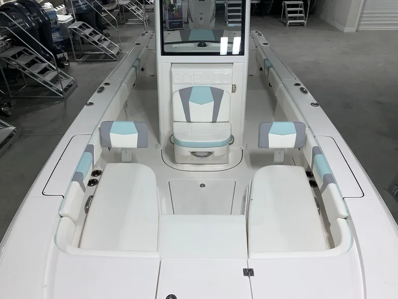 Slide: The Image of 2024 Robalo 266 Cayman boat interior with white and blue seating. - 7
