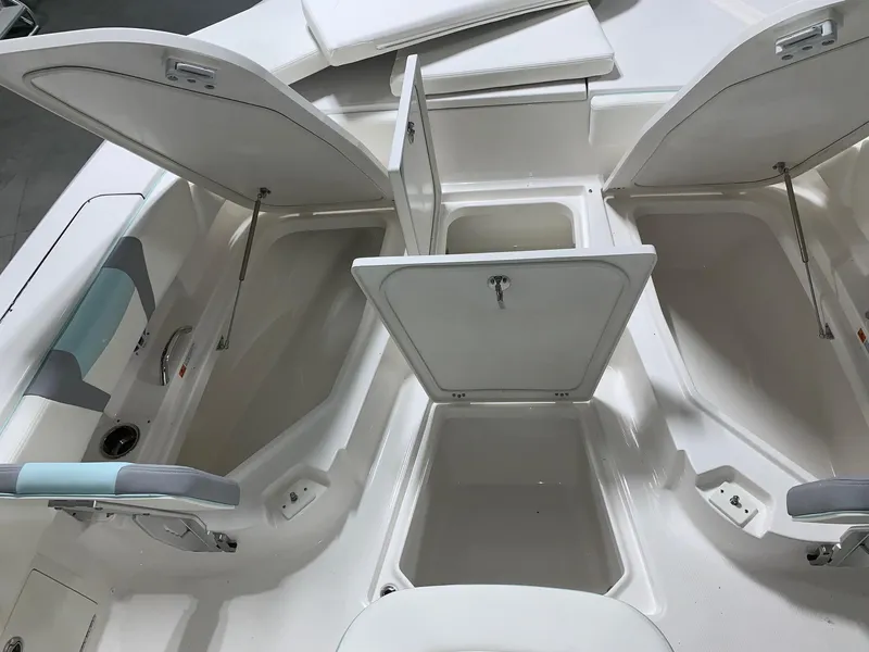 Slide: The Image of 2024 Robalo 266 Cayman boat storage compartments open. - 9