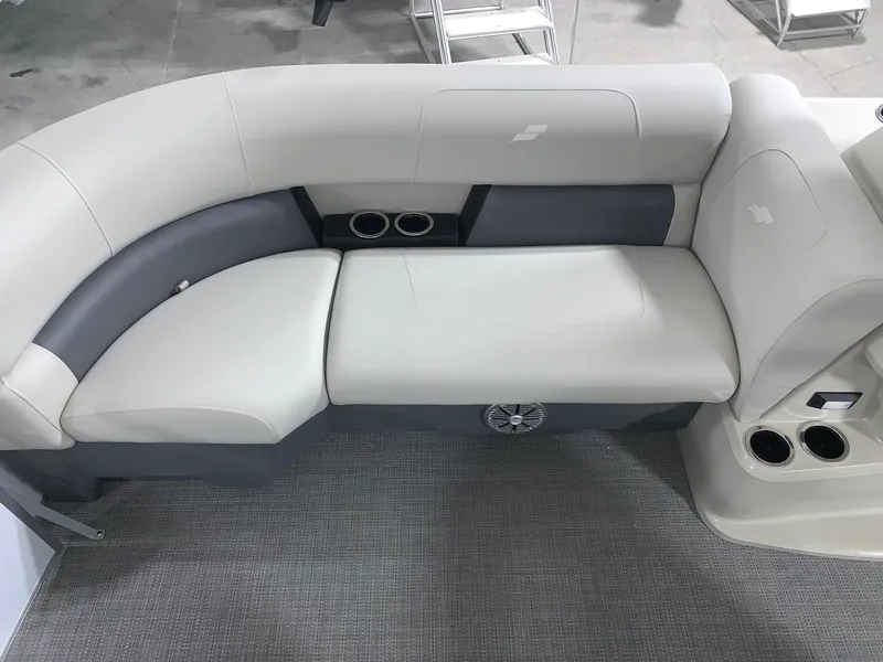 Slide: The Image of 2024 Starcraft LX22 R boat interior seating with cup holders and speaker. - 5