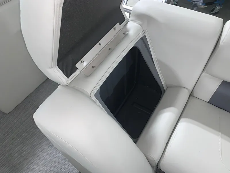 Slide: The Image of 2024 Starcraft LX22 R boat storage compartment with open seat cushion. - 7
