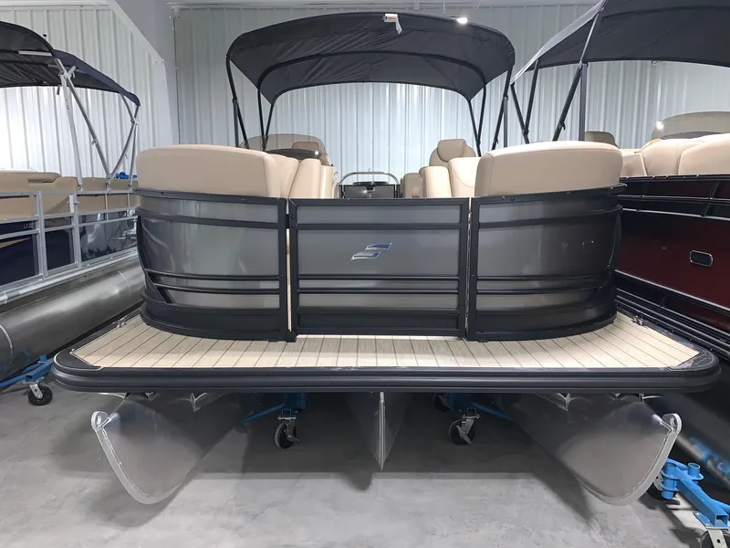 Slide: The Image of 2024 Starcraft SLS 3 pontoon boat in showroom. - 2