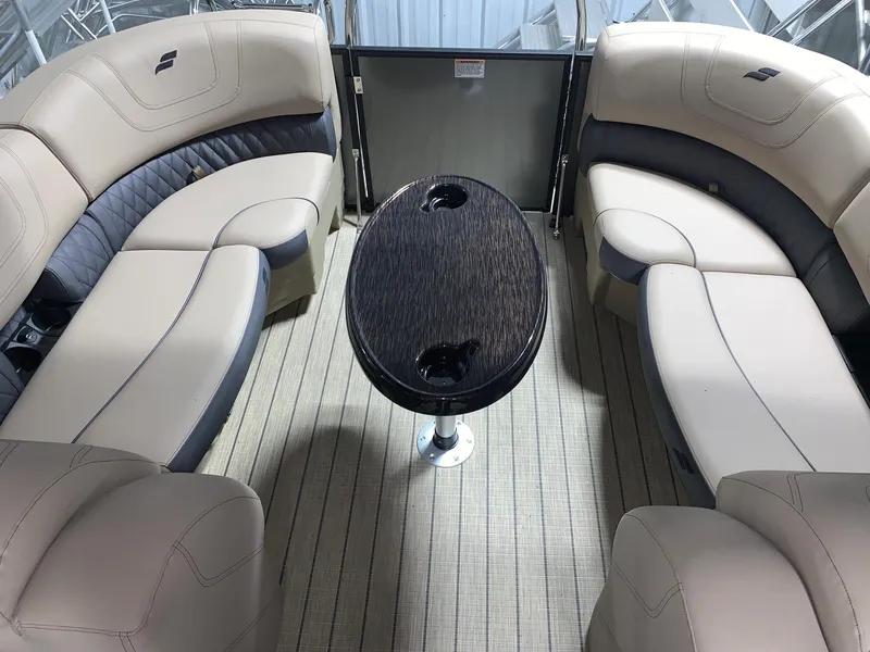 Slide: The Image of 2024 Starcraft SLS 3 boat interior with beige seating and central table. - 3