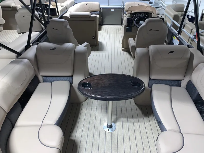 Slide: The Image of 2024 Starcraft SLS 3 boat interior with beige seating and a central table. - 5