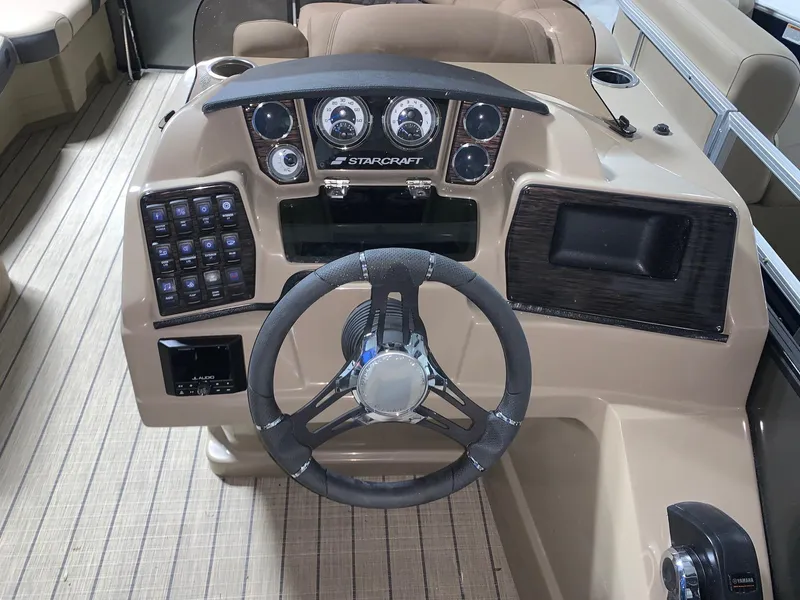 Slide: The Image of 2024 Starcraft SLS 3 boat dashboard with steering wheel and control panel. - 8