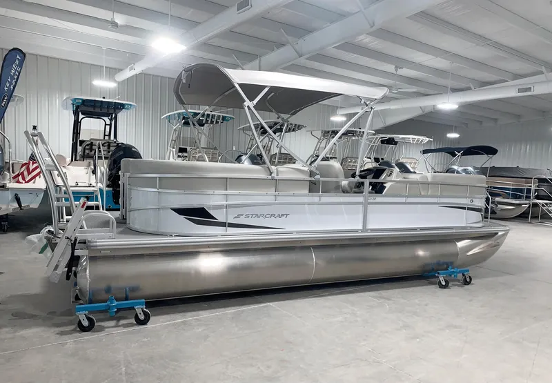 Slide: The Image of 2024 Starcraft LX22 R pontoon boat in showroom. - 0