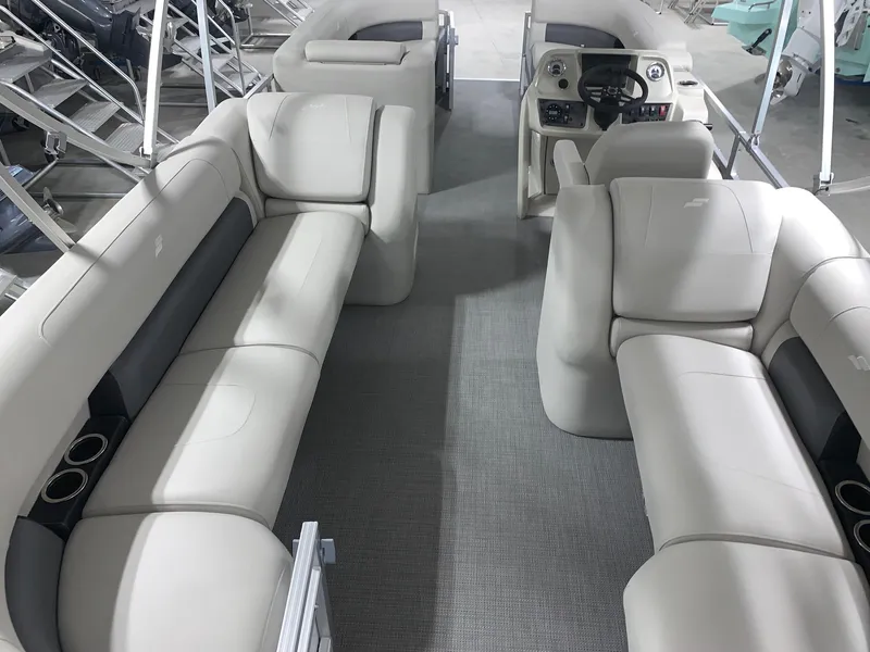 Slide: The Image of 2024 Starcraft LX22 R pontoon boat interior with plush seating and modern helm. - 10