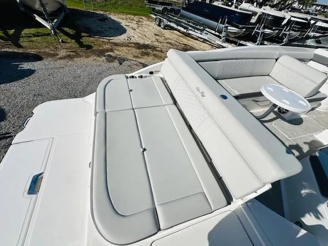 Slide: The Image of 2021 Sea Ray 270 SDX boat with spacious seating and sunbathing area. - 12