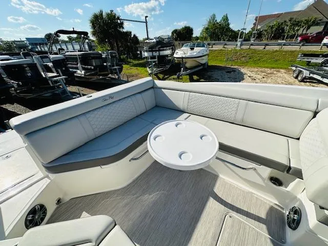 Slide: The Image of 2021 Sea Ray 270 SDX boat interior with white seating and round table. - 13