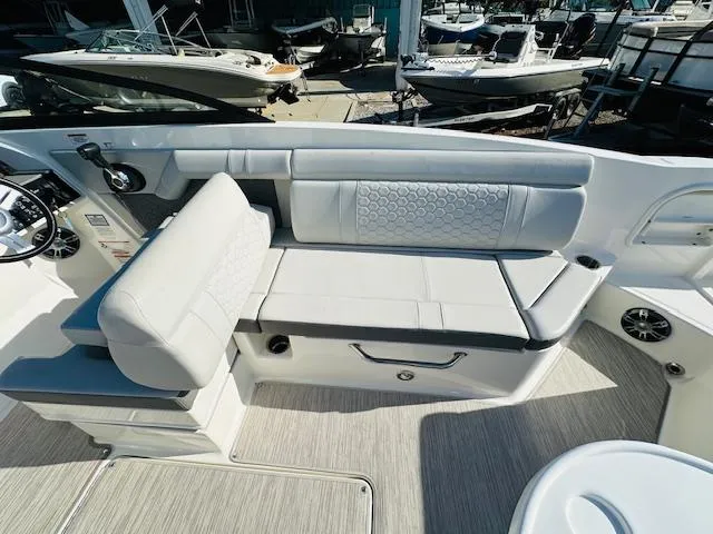Slide: The Image of 2021 Sea Ray 270 SDX boat interior with white seating and modern design. - 15
