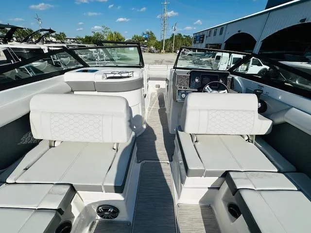 Slide: The Image of 2021 Sea Ray 270 SDX boat interior with white seating and modern dashboard. - 16