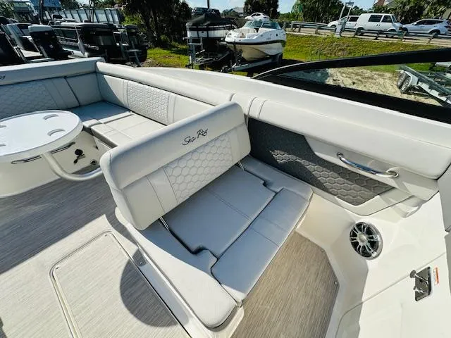 Slide: The Image of 2021 Sea Ray 270 SDX boat interior with white seating and table. - 17