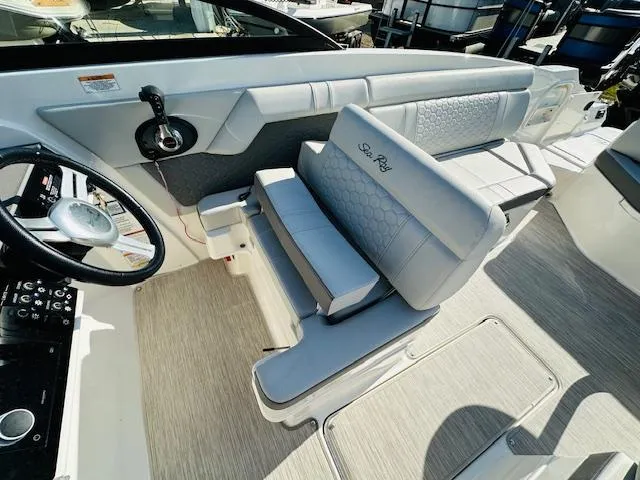Slide: The Image of 2021 Sea Ray 270 SDX boat interior with steering wheel and seating. - 18