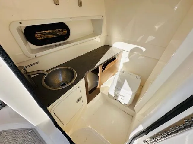 Slide: The Image of 2021 Sea Ray 270 SDX cabin interior with sink, storage, and toilet. - 22