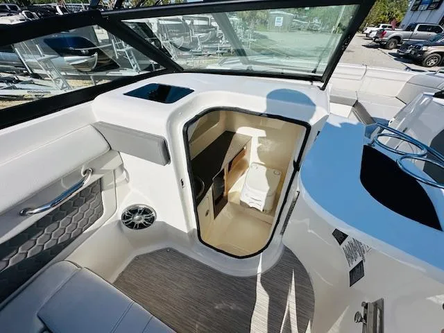 Slide: The Image of 2021 Sea Ray 270 SDX boat interior with open cabin and seating area. - 23
