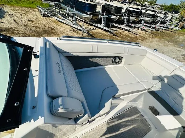 Slide: The Image of 2021 Sea Ray 270 SDX boat interior with white seating and speaker. - 26