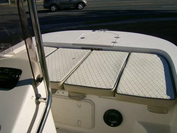 Slide: The Image of 2021 Carolina Skiff 17 LS boat interior with cushioned seating and storage compartments. - 7