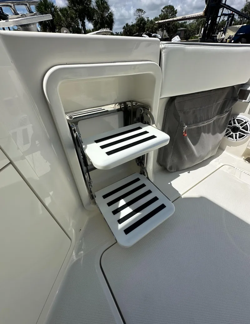 Slide: The Image of 2021 World Cat 400 DC-X boat with foldable steps and storage compartment. - 12
