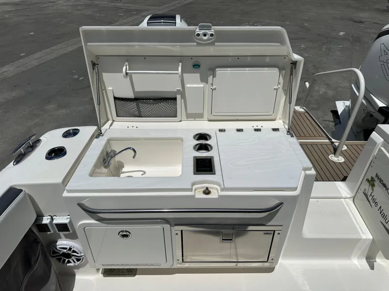 Slide: The Image of 2021 World Cat 400 DC-X boat with a built-in sink and storage area. - 14