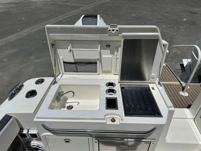 Slide: The Image of Outdoor kitchen on a 2021 World Cat 400 DC-X boat with sink and grill. - 15