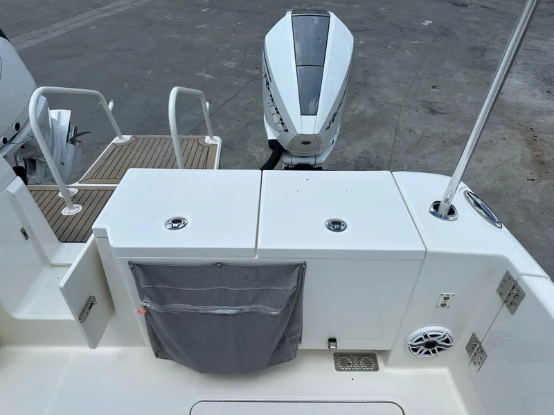 Slide: The Image of 2021 World Cat 400 DC-X boat stern with outboard motor and deck features. - 16