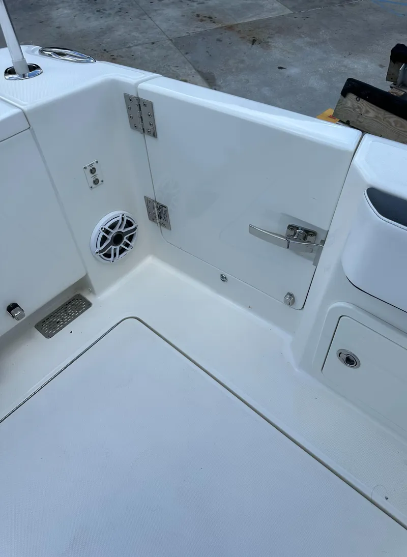 Slide: The Image of 2021 World Cat 400 DC-X boat deck with speaker and storage compartments. - 18