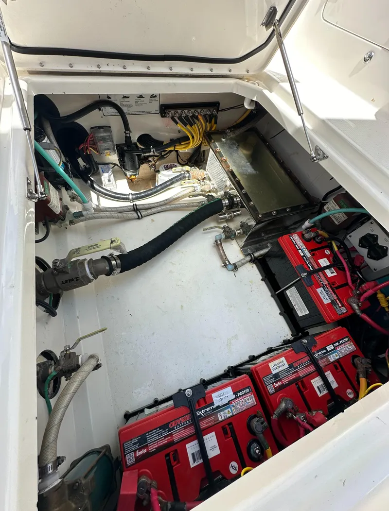 Slide: The Image of Engine compartment of a 2021 World Cat 400 DC-X boat with batteries and wiring. - 21