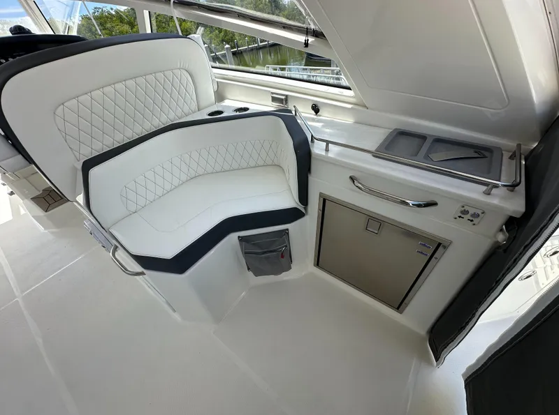 Slide: The Image of Luxurious seating and kitchenette area on the 2021 World Cat 400 DC-X boat. - 23