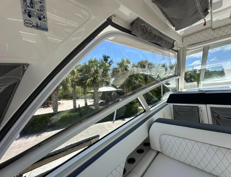 Slide: The Image of Interior view of 2021 World Cat 400 DC-X boat with palm trees outside. - 26