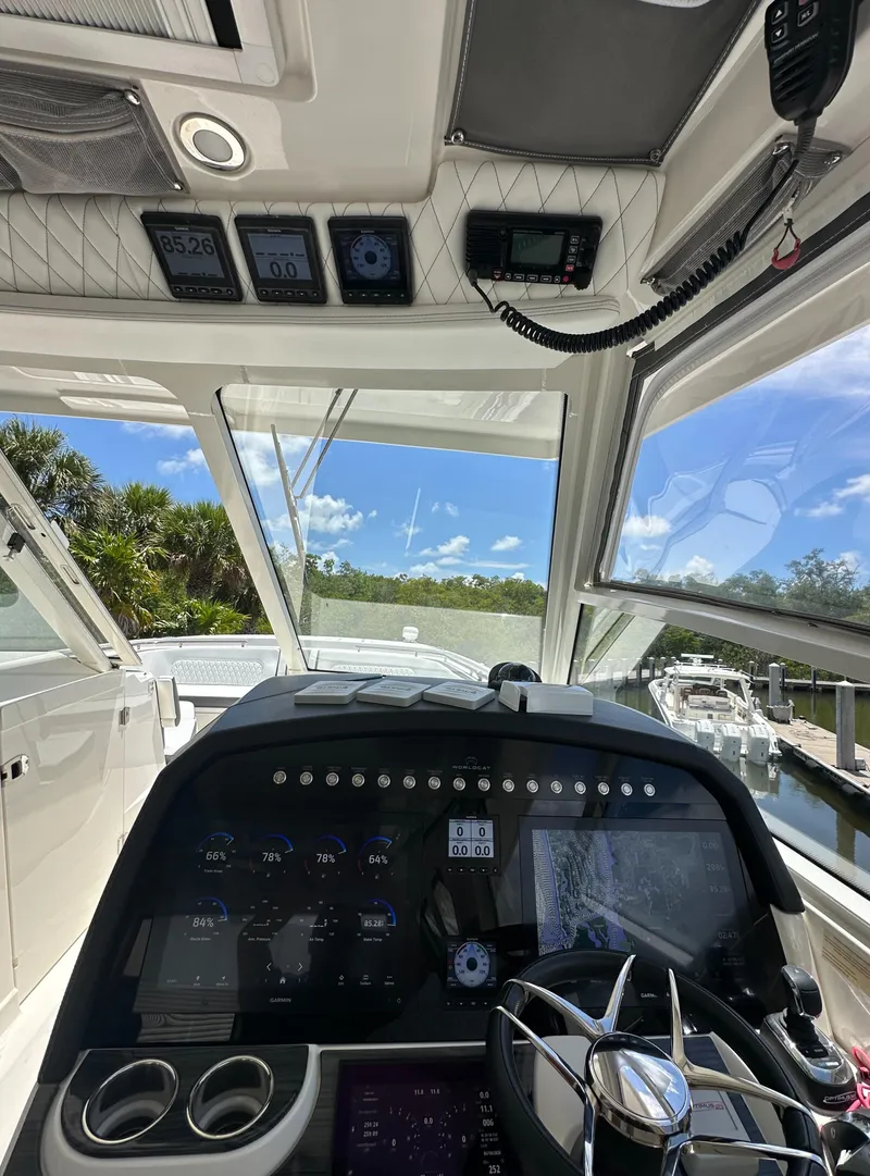 Slide: The Image of 2021 World Cat 400 DC-X boat cockpit with advanced navigation system and scenic view. - 31