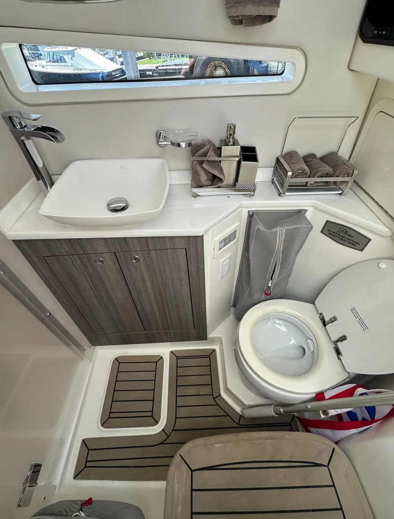 Slide: The Image of Modern bathroom in 2021 World Cat 400 DC-X boat with sink, toilet, and storage. - 40