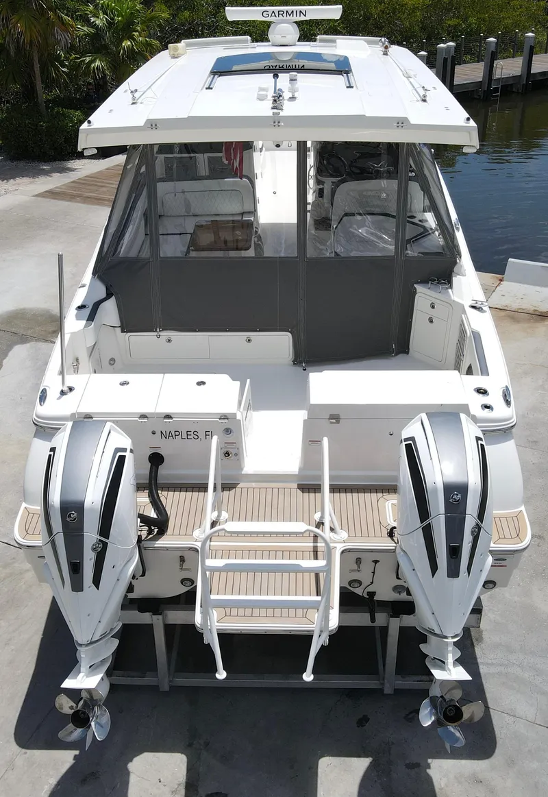 Slide: The Image of 2021 World Cat 400 DC-X boat with twin outboard engines, docked. - 7
