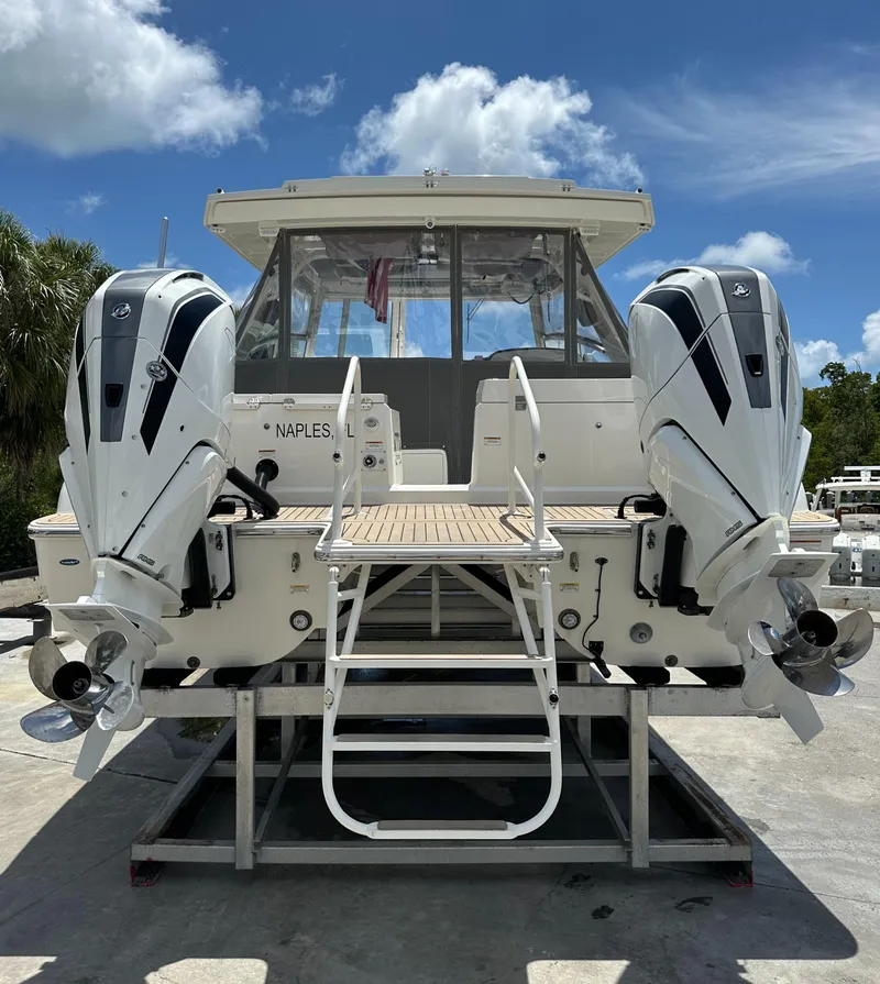 Slide: The Image of 2021 World Cat 400 DC-X boat with twin outboard engines in Naples. - 8
