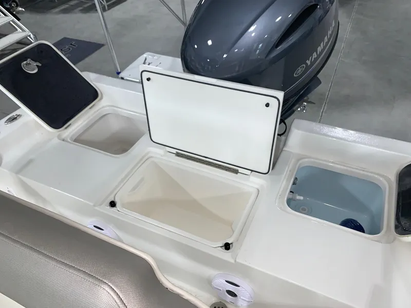 Slide: The Image of 2024 Key West 188 Bay Reef boat with open storage compartments and Yamaha engine. - 12
