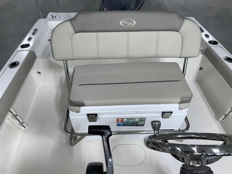 Slide: The Image of 2024 Key West 188 Bay Reef boat interior with cushioned seating and steering wheel. - 10