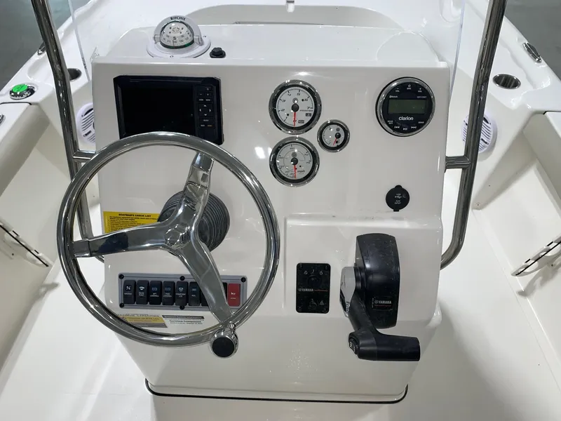 Slide: The Image of 2024 Key West 188 Bay Reef boat console with steering wheel, gauges, and controls. - 11
