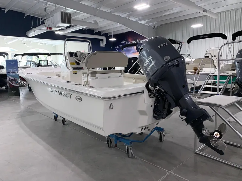 Slide: The Image of 2024 Key West 188 Bay Reef boat in showroom with Yamaha outboard motor. - 2