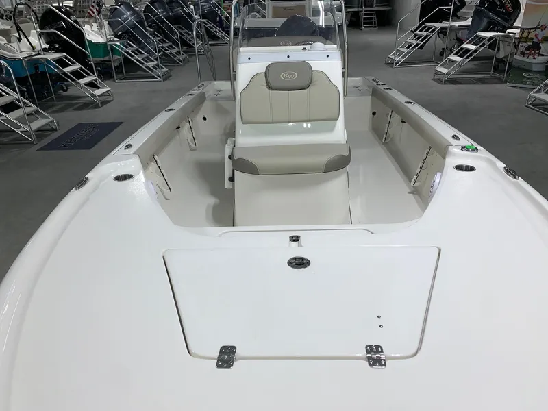 Slide: The Image of 2024 Key West 188 Bay Reef boat interior, white and beige seating, showroom display. - 4
