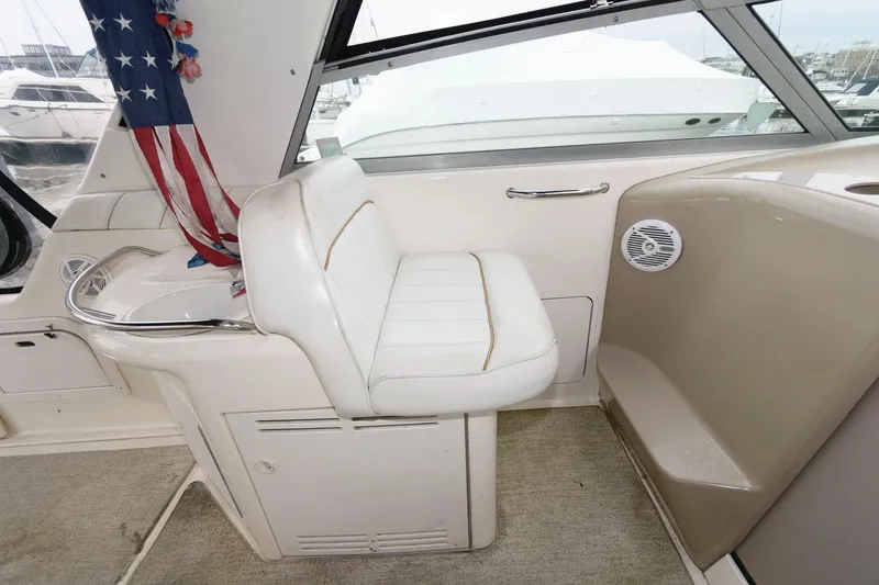 Slide: The Image of 1998 Sea Ray 330 Sundancer interior with white seating and American flag. - 10