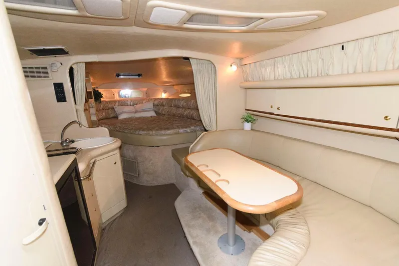 Slide: The Image of Interior of 1998 Sea Ray 330 Sundancer yacht with cozy seating and kitchenette. - 11
