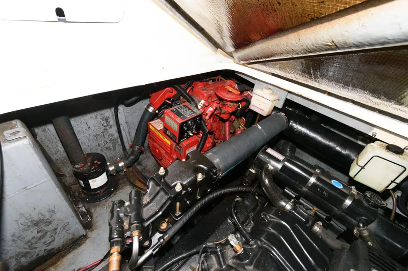 Slide: The Image of Engine compartment of 1998 Sea Ray 330 Sundancer boat, showcasing mechanical components. - 19