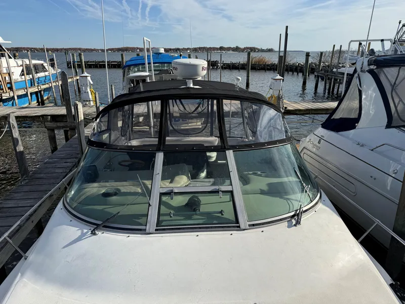 Slide: The Image of 1998 Sea Ray 330 Sundancer docked at marina, clear sky, calm water. - 2