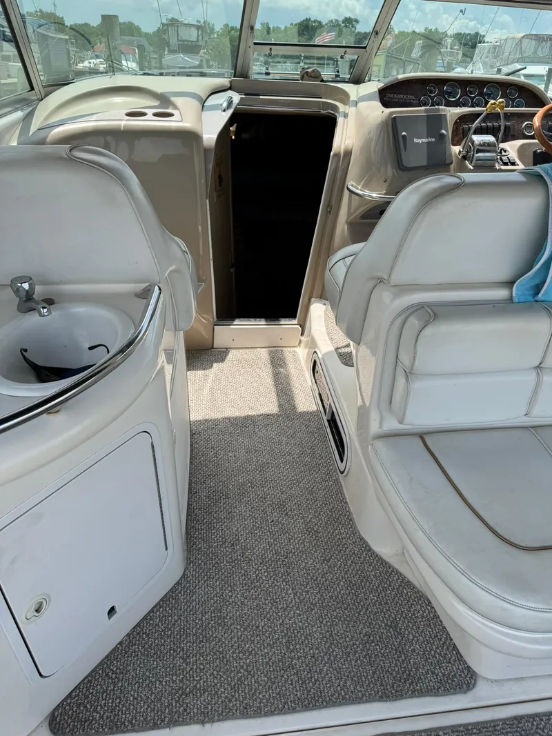 Slide: The Image of 1998 Sea Ray 330 Sundancer interior with helm, seating, and sink. - 4