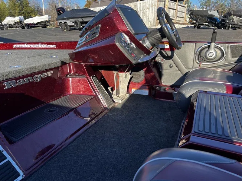 Slide: The Image of 2018 Ranger Z519C boat interior with steering wheel and seating. - 12