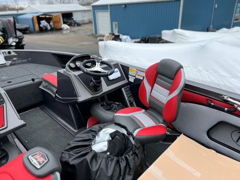 Slide: The Image of 2023 Ranger 1850MS boat interior with red and gray seats, steering wheel, and dashboard. - 4